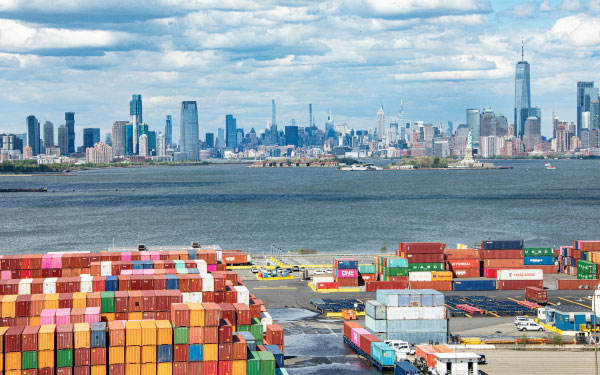 Aerial view of colorful shipping containers at the port of New York and New Jersey with the New York City skyline in the background 