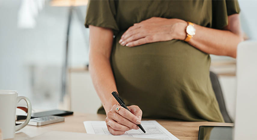 woman resting hand on pregnant belly