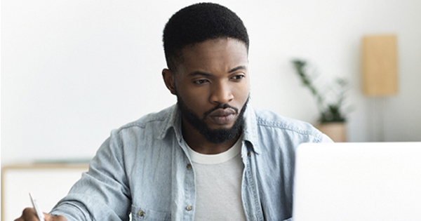 Man sitting at laptop using Retirement Online